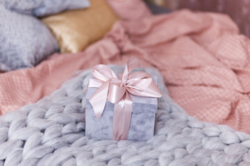 gift box with pink bow on the bed with pink bed