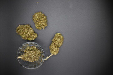 Assorted weed and joints in jars on black surface