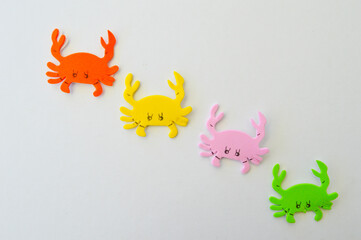 four colored eva rubber crabs diagonally isolated on white background