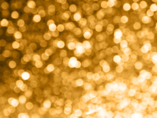Abstract colorful orange and silver small bokeh Look bright effect texture on black background. glitter vintage lights defocused elegant for cosmetics or celebrate. Sparkling magical dust particles.