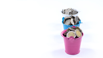 Metal bucket containing silver coins