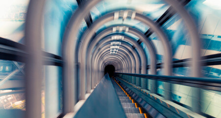 Abstract motion blurred view through an escalator tunnel