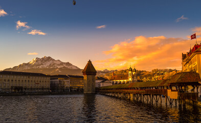 Lucerne city landscape showing wooden water tower and chapel bridge