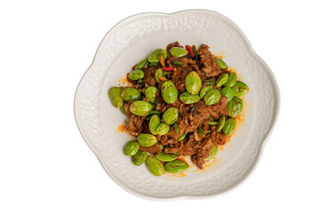 Stir fried bitter bean (Sator) with pork in white plate isolate on white background.Traditional Thai Food: Pad Ped Sator Moo.