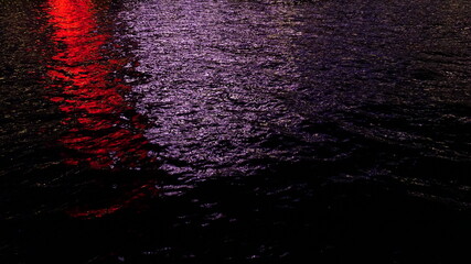 Red and White reflection on sea at night, background