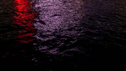 Red and White reflection on sea at night, background