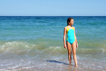 a girl in a swimsuit against the background of the sea horizon