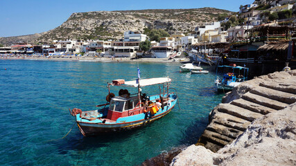 Fototapeta na wymiar Matala village with fishing boat in Crete. Greece