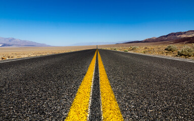 Lonely straight road to the sky in the desert