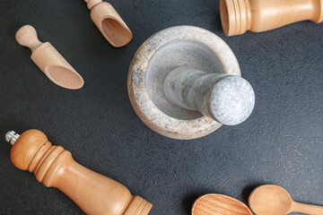 stone mortar and wooden spoon for lights on the table top view