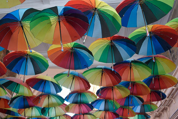 Fototapeta na wymiar Multi coloured umberallas make a shady canopy over the side streets of Bucharest