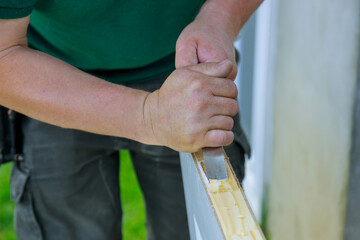Carpenter working using a chisel a hinge wooden door installation a hinge