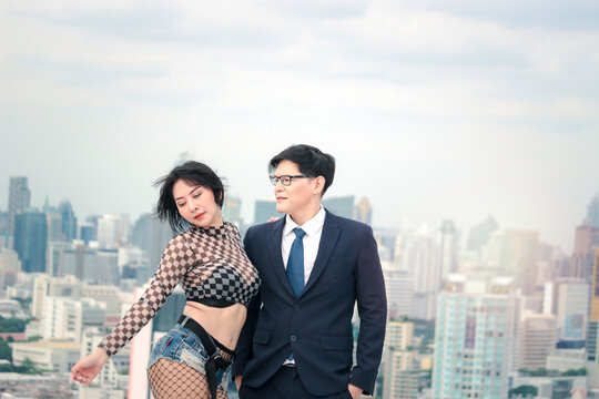 Couple standing and hugging, businessman in suit and attractive sexy woman have a crush on each other