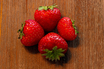 red sweet strawberries on a beautiful brown table