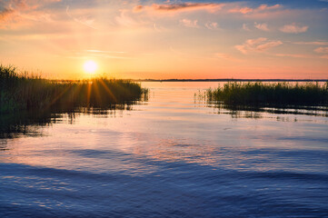 sunset over the lake Chiemsee in Germany (mosquitos over the water)