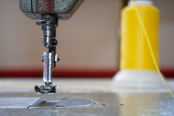sewing machine foot and needle. Close up, macro. Empty space for text. Craft fabric industrial.