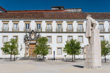 statue in the courtyard of  coimbra university.
View on the courtyard of the old university with university tower in Coimbra city in the central Portugal