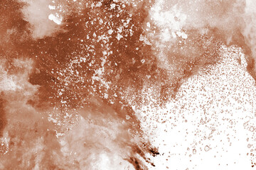 Brown color powder explosion on white background. Colored cloud. Colorful dust explode. Paint Holi.