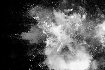 White powder explosion on black background. Colored cloud. Colorful dust explode. Paint Holi.