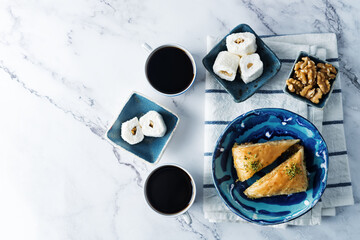 Turkish delight. Baklava and coconut lukum with cups of coffee