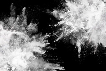 White powder explosion on black background. Colored cloud. Colorful dust explode. Paint Holi.