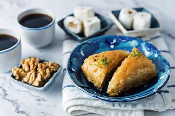 Turkish delight. Baklava and coconut lukum with cups of coffee