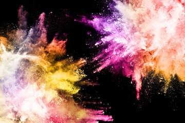 abstract colored dust explosion on a black background.abstract powder splatted background,Freeze motion of color powder exploding/throwing color powder, multicolored glitter texture.