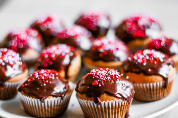 homemade cupcakes and muffins with chocolate toppings and decorations