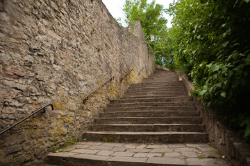 Fototapeta na wymiar An old stone staircase leading to the sights.