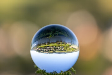 Crystal ball with landscape on wooden table
