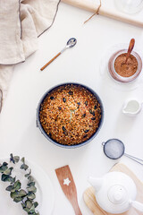 Delicious homemade pie  poppy seeds and nuts on a white table surrounded by dishes and kitchen utensils,poppy seed cake. Top view, flat lay, Top-down food