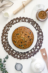 Delicious homemade pie with poppy seeds and nuts on a white table surrounded by dishes and kitchen utensils,poppy seed cake. Top view, flat lay, Top-down food