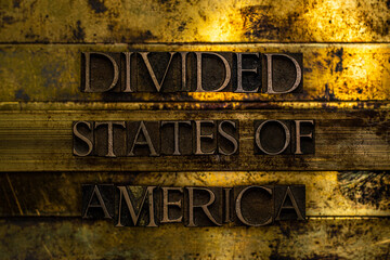 Divided States of America text formed with real authentic typeset letters on vintage textured silver grunge copper and gold background