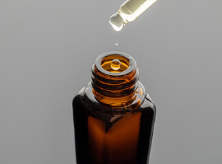 A bottle of essential oil with a dropper