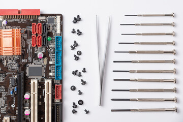 on a white background laid out the motherboard and other computer components and tools