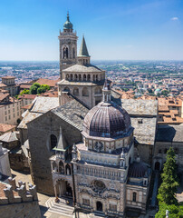 Fototapeta na wymiar Bergamo, Italy. The old town. Amazing aerial view of the Basilica of Santa Maria Maggiore and the chapel Colleoni. Landscape of the city center and Its landmarks during a wonderful day. Best of Italy