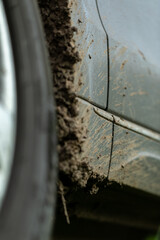 Off-road dirty car. Detail of a car with adhering dirt.