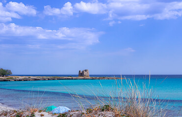 Fototapeta na wymiar Marina di Lizzano: Torretta Beach, Apulia (Italy).On background Zozzoli Watchtower. The coastline is characterized by a alternation of sandy coves and jagged cliffs overlooking a crystalline sea.