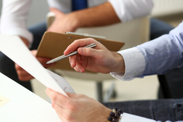 Group of businessmen with financial graph and silver pen in arm solve and discuss problem with colleague closeup. Situation examination at board council sale adviser job stock exchange market profit