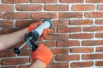Grouting decorative gypsum brick with white cement grout.