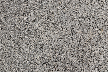 Grey marble background with grey and black flecks, top view