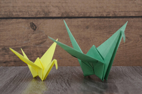 Origami paper cranes on wooden