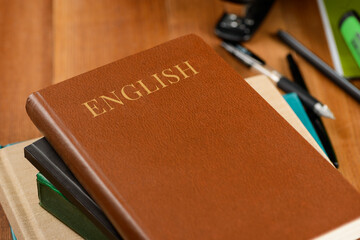 Books and office products on wooden desktop