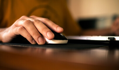 man's hand working with computer mouse