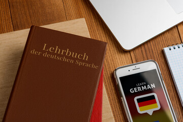Learning German book and app. Using phone to do exercises