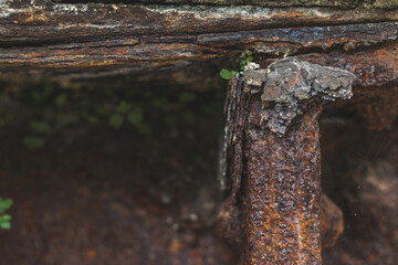 Closeup of a rough and rusty construction. Old and with moss growing