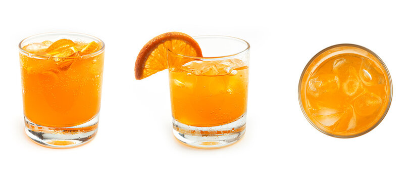 Orange lemonade with ice and slices of fresh orange in a transparent low glass on a white background. High quality photo.