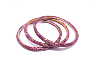 Three multicolored Bangles isolated on white background. Bangles are traditionally rigid bracelets, originating from the Indian subcontinent, which are usually made of metal, wood, glass or plastic.