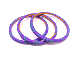 Fototapeta premium Multicolored Bangles isolated on white background. Bangles are traditionally rigid bracelets, originating from the Indian subcontinent, which are usually made of metal, wood, glass or plastic.