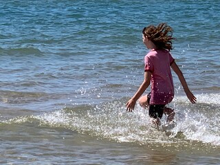 little girl running in the sea